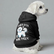 Maltese dog wearing a 'Bark Less, Wag More' hoodie