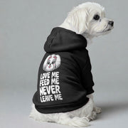 Maltese dog wearing a 'Love Me, Feed Me, Never Leave Me' hoodie